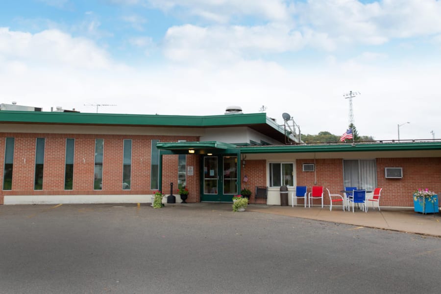 The main entrance of Whitewater Healthcare, with its covered portico and patio seating